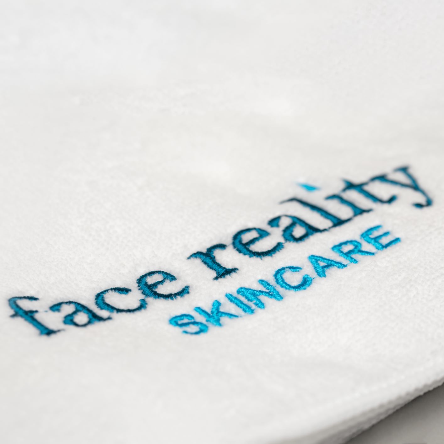 Face Reality Skincare logo on towel